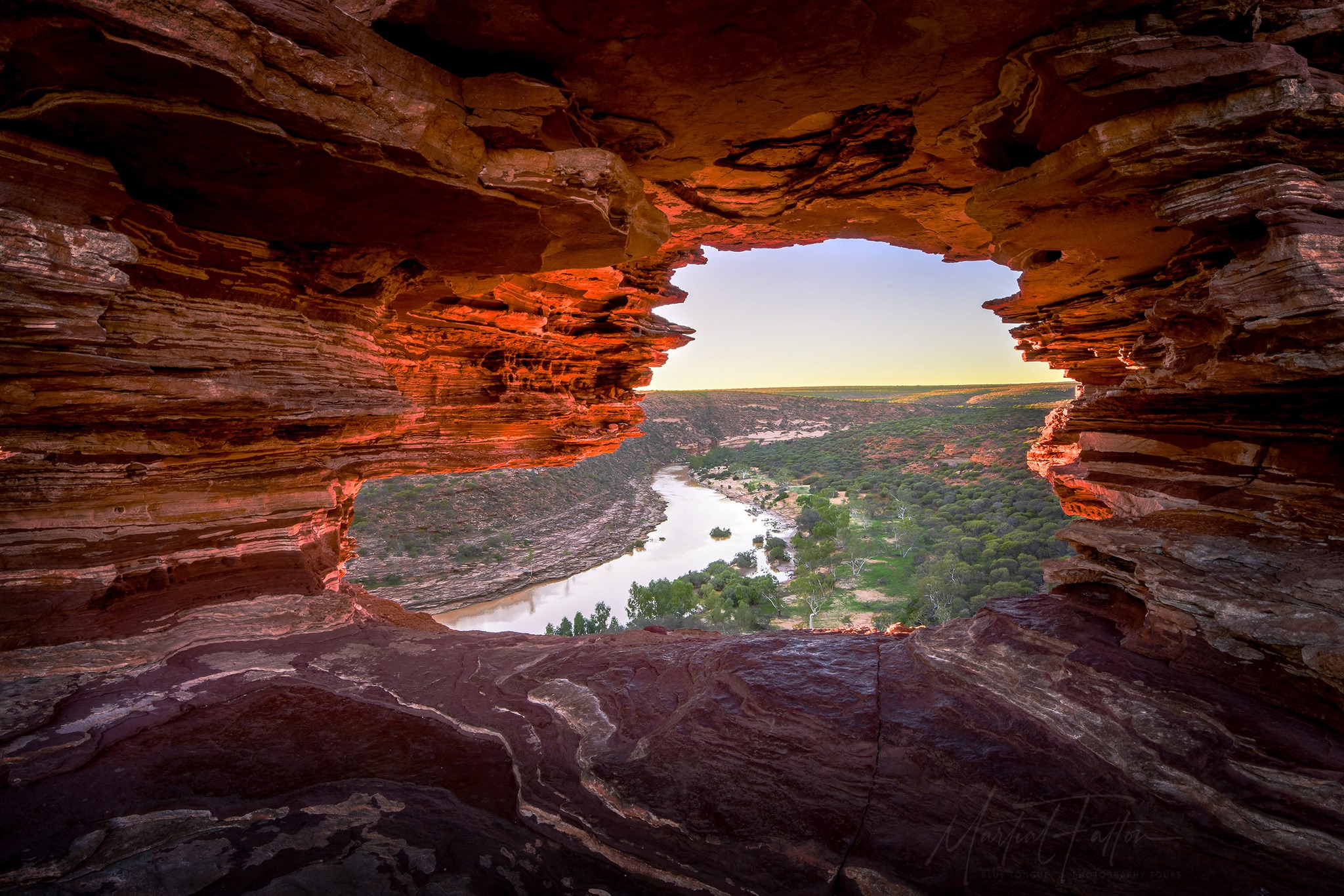 Scenic view through Nature’s Window rock formation in Kalbarri National Park, looking out over the winding Murchison River and green gorge below.