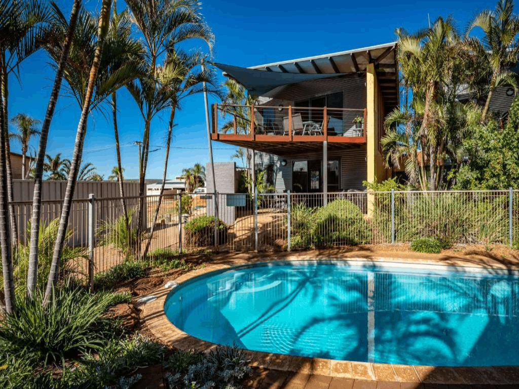 Modern two-storey Kalbarri holiday home with private pool, tropical garden and shaded balcony.