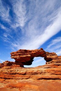 A natural rock arch formation known as Nature’s Window framing blue sky and desert landscape in Kalbarri National Park, Western Australia.